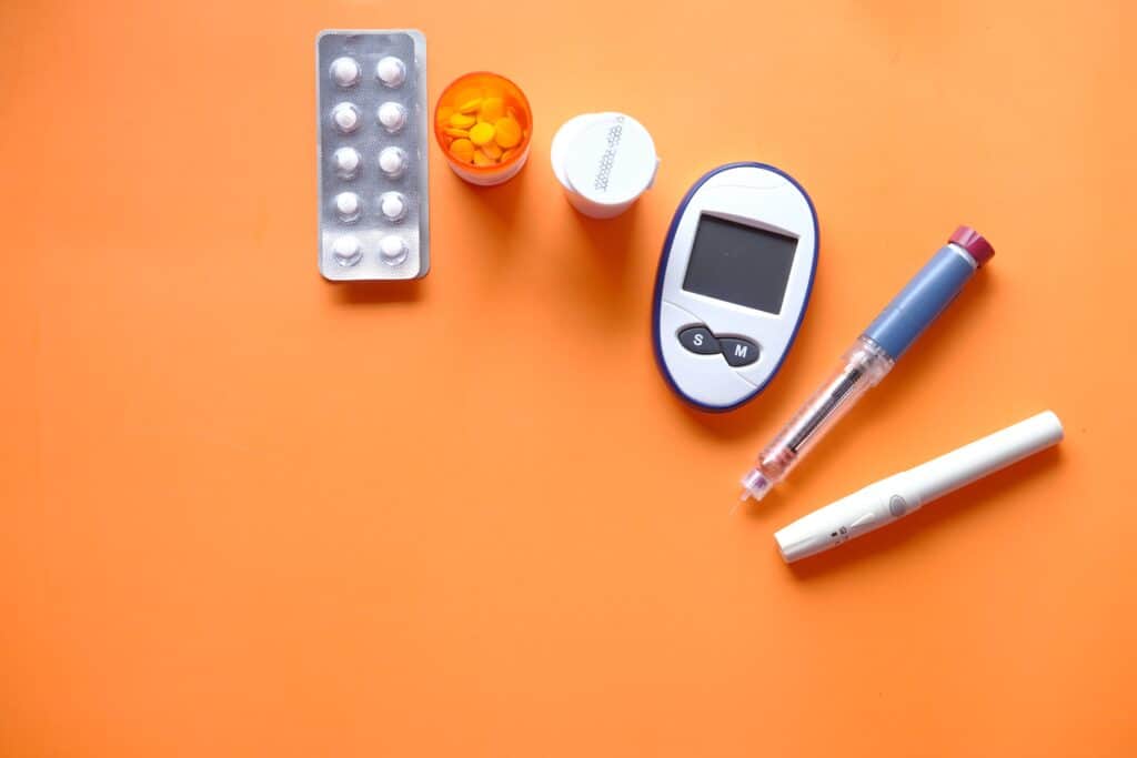 Diabetes management equipment on an orange table