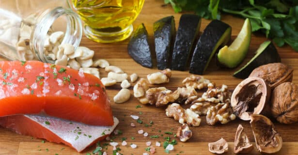 a variety of protein rich foods including salmon, cashews, and avocado